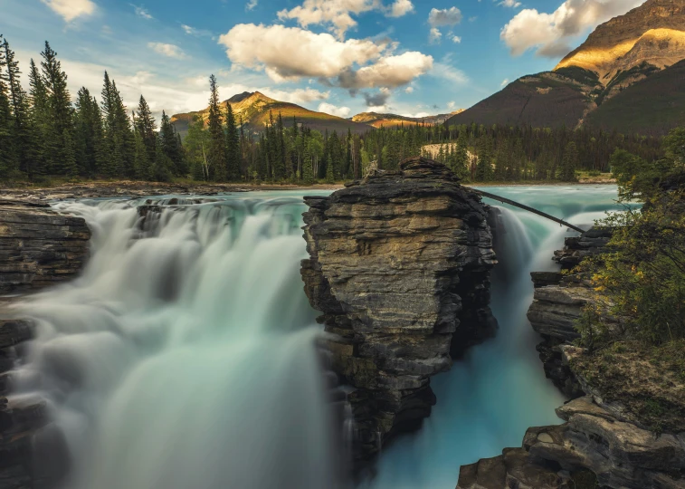 a waterfall in the middle of a forest, by Erik Pevernagie, pexels contest winner, banff national park, erosion algorithm landscape, turbulent lake, skies behind