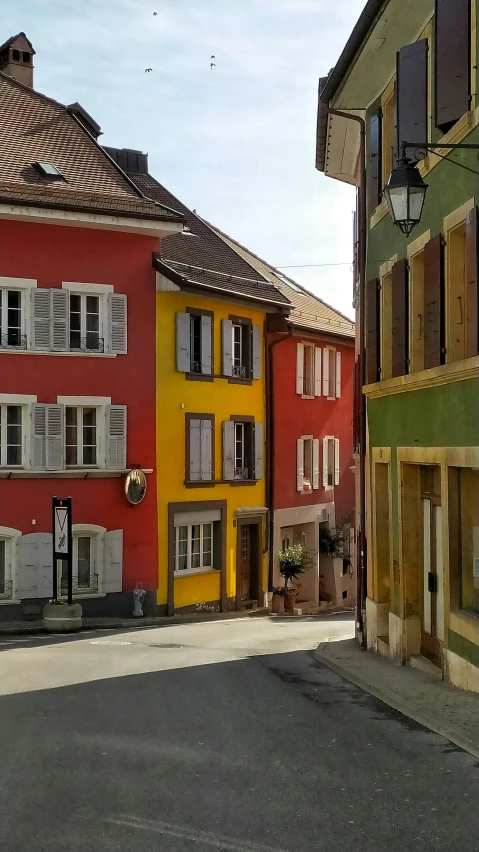 a couple of buildings that are next to each other, a digital rendering, inspired by Karl Stauffer-Bern, pexels, renaissance, red yellow, street, green, three colors