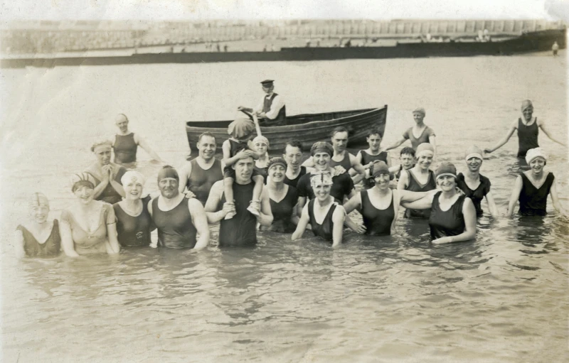 a group of people standing in a body of water, a black and white photo, shutterstock, art nouveau, dingy gym, thumbnail, coloured, in group photograph