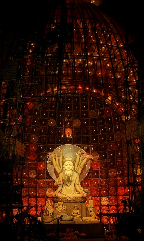 a statue that is inside of a building, inspired by Buckminster Fuller, assemblage, guanyin, lit from above, movie filmstill, cathedral of sun