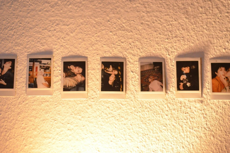 a group of polaroids hanging on a wall, inspired by Nan Goldin, serial art, ukiyo e, 33mm photo, night photo, wall ]