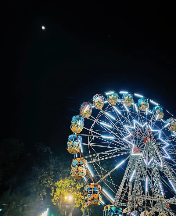 a large ferris wheel sitting in the middle of a park, by Niko Henrichon, pexels contest winner, themed on the stars and moon, profile image, square, festivals