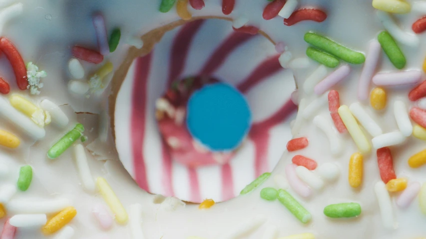 a close up of a frosted donut with sprinkles, inspired by Wayne Thiebaud, unsplash, c 4 d ”, eye closeup, multi - coloured, shot on sony a 7