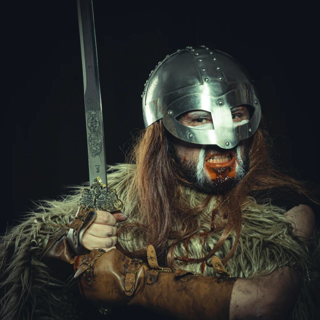 a man dressed in a viking costume holding a sword, an album cover, pexels contest winner, barbarian warrior woman, high quality photo, metal mask, manbearpig