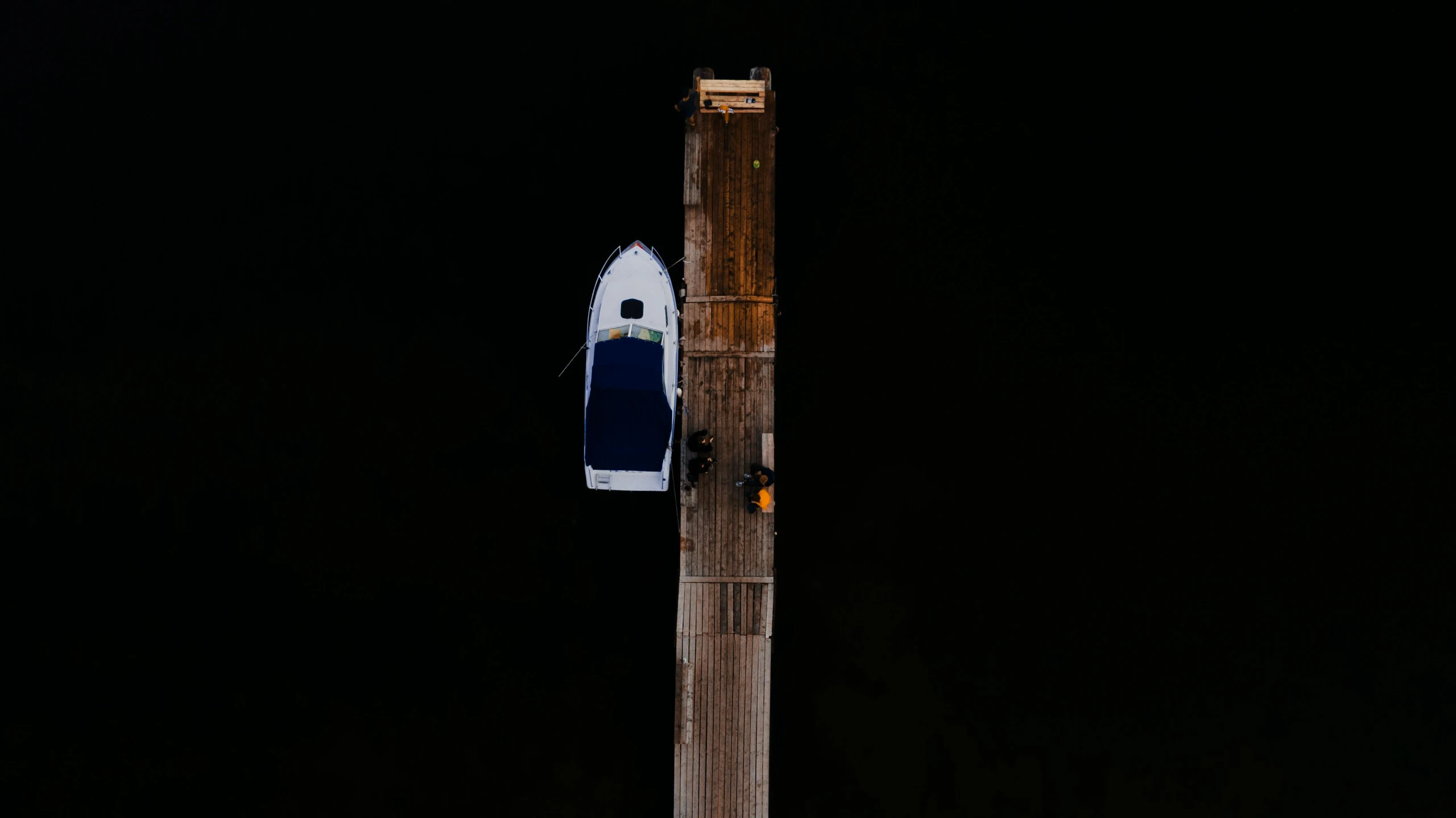 a blue and white boat sitting on top of a wooden pole, a portrait, by Jan Rustem, pexels contest winner, postminimalism, aerial photo night vision, on black background, low detailed, docks