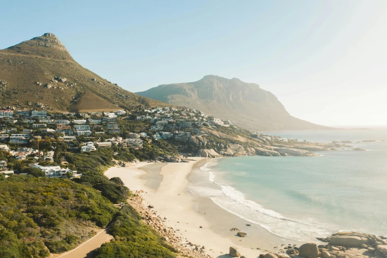 a view of a beach from the top of a hill, by Daniel Lieske, unsplash contest winner, cape, slightly sunny, whitewashed buildings, “ aerial view of a mountain