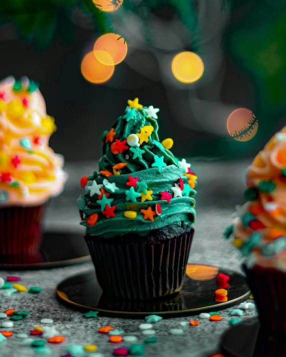 a table topped with cupcakes covered in frosting and sprinkles, a colorized photo, by Julia Pishtar, pexels, christmas tree, very dark with green lights, profile image, made of food