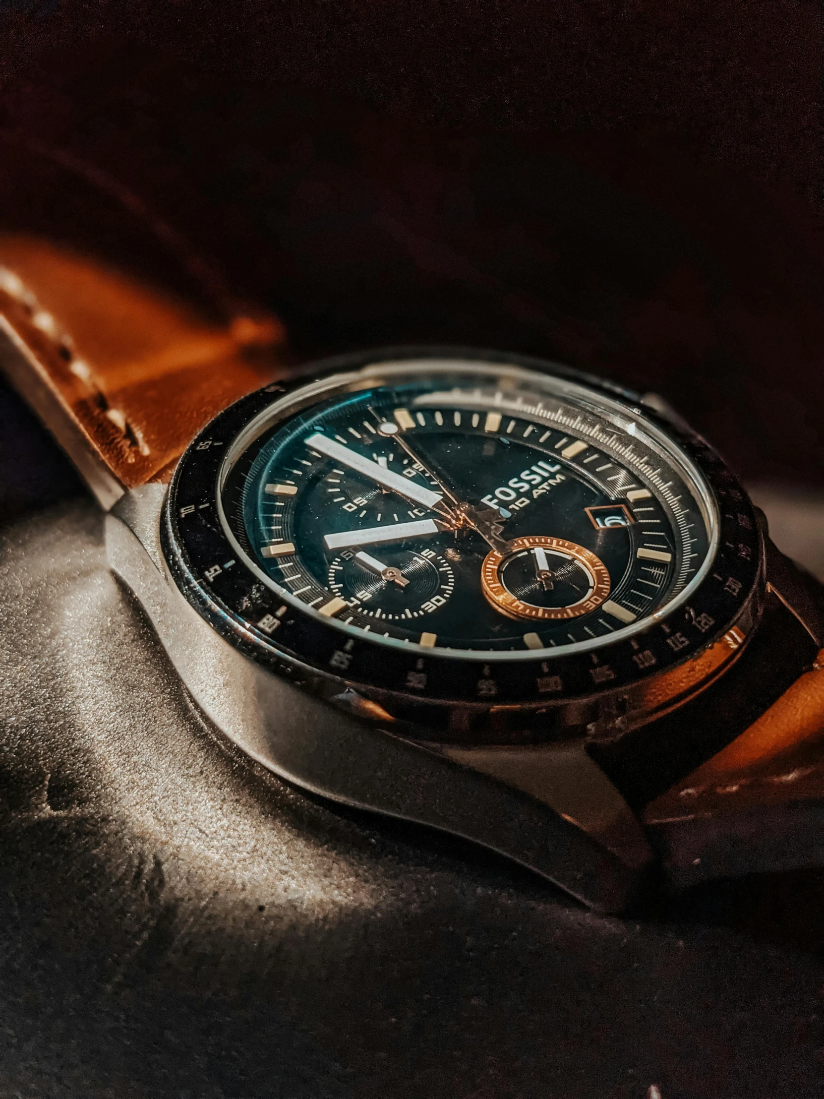 a close up of a watch on a table, by Robbie Trevino, thumbnail, rugged | stars, apollo, black and brown colors