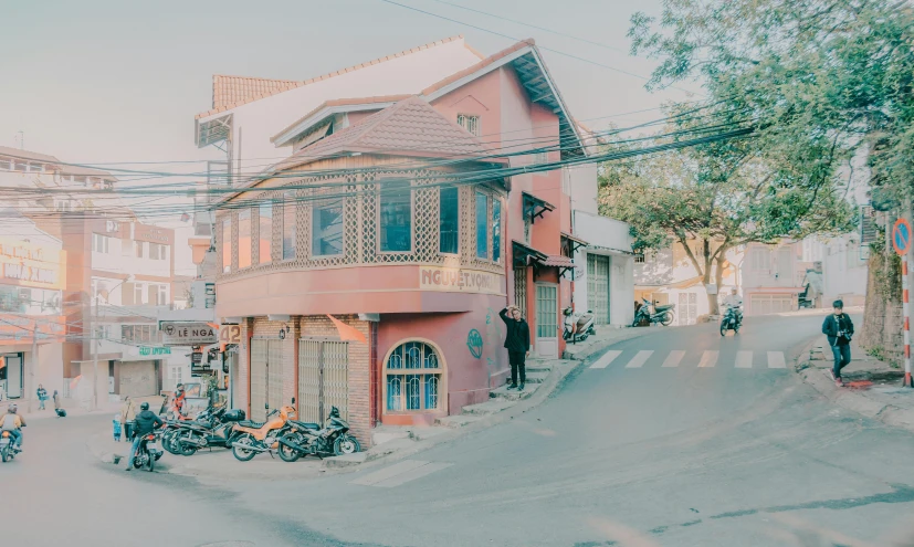 a group of motorcycles parked on the side of a road, pexels contest winner, art nouveau, red building, thawan duchanee, sunfaded, house on a hill