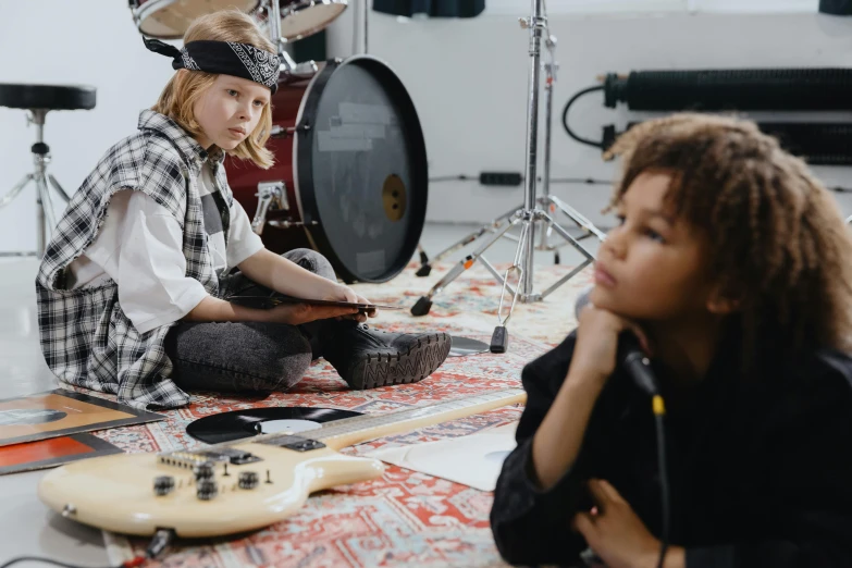 two young girls sitting on the floor playing drums, pexels contest winner, cute boys, holding an electric guitar, ouchh and and innate studio, future activist