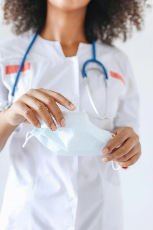 a woman with a stethoscope in her hand, a picture, shutterstock, white mask, square, wearing gloves, no crop