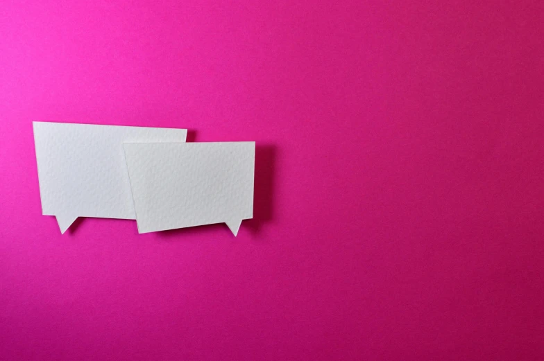 two white paper speech bubbles on a pink background, by Rachel Reckitt, trending on pexels, postminimalism, business card, origami, modeled, whiteboards