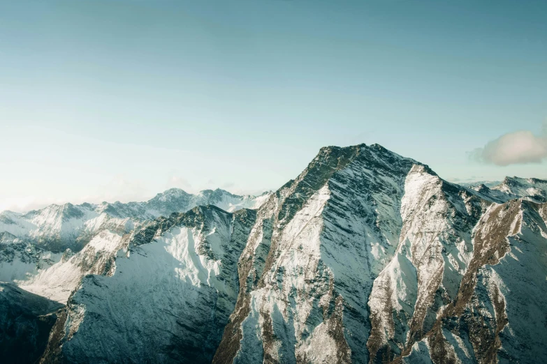 a person standing on top of a snow covered mountain, unsplash contest winner, minimalism, “ aerial view of a mountain, highly detailed textured 8k, 4 k hd wallpapear, towering high up over your view