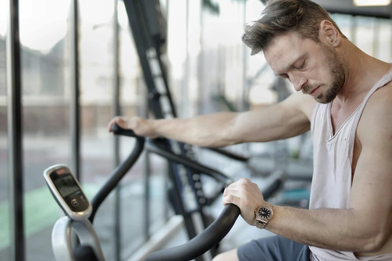 a man sitting on a stationary bike in a gym, pexels contest winner, renaissance, holding gold watch, avatar image, profile image, lachlan bailey