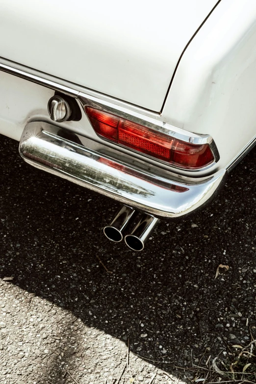 a white car parked on the side of the road, by Tom Bonson, pexels contest winner, photorealism, metal tail, pipes, tail lights, silver