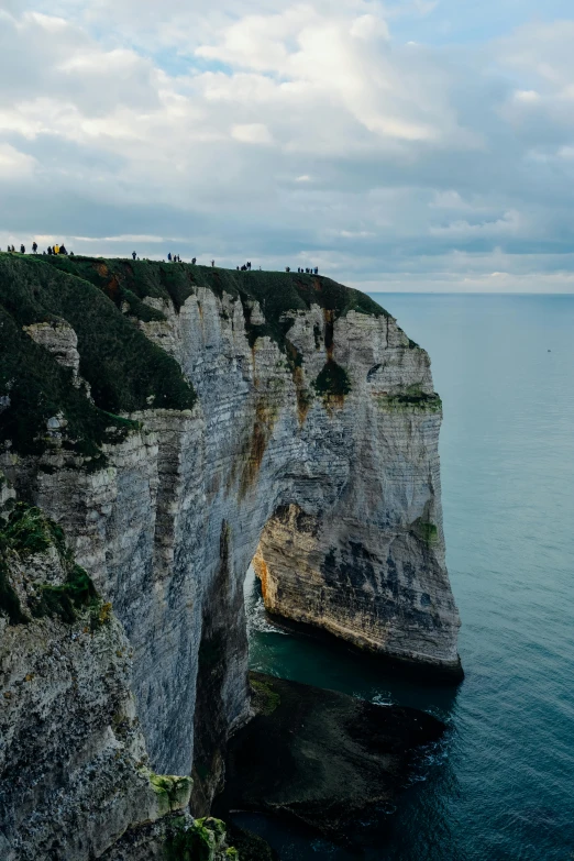 a lighthouse sitting on top of a cliff next to the ocean, normandy, sky bridge, epic land formations, slide show