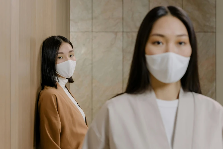 a woman wearing a face mask standing next to another woman, trending on pexels, sōsaku hanga, zeen chin and terada katsuya, beige, blank, promotional image