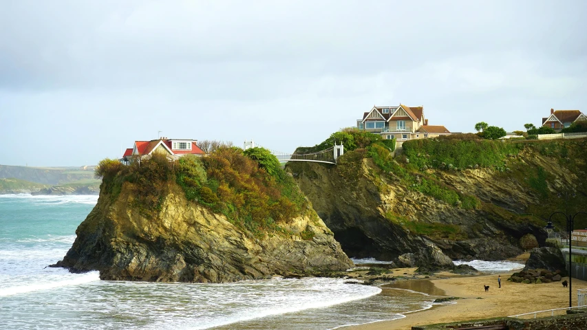 a house sitting on top of a cliff next to the ocean, cottages, profile image