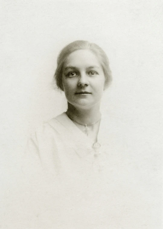 an old black and white photo of a woman, a black and white photo, by Flora Macdonald Reid, liz truss, color portrait, may gibbs, frontal portrait