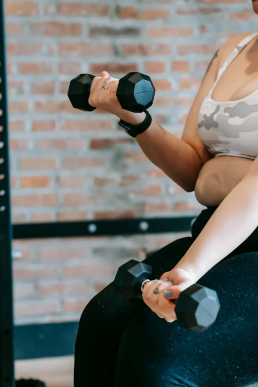 a woman sitting on top of an exercise ball, pexels contest winner, realism, carrying two barbells, partially cupping her hands, hexagonal shaped, instagram story