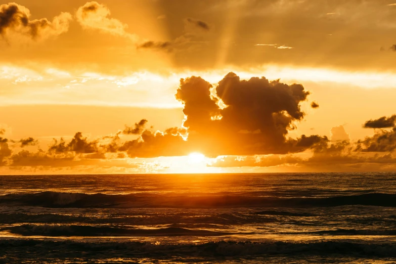 the sun is setting over the ocean on a cloudy day, pexels contest winner, golden glow, kauai, youtube thumbnail, bright sunlight