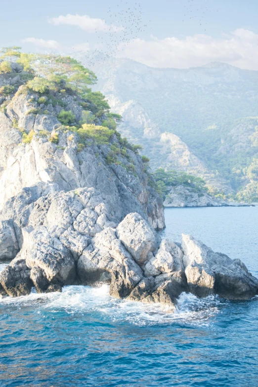 a large rock in the middle of a body of water, capri coast, slide show, mountainous jungle setting, caparisons