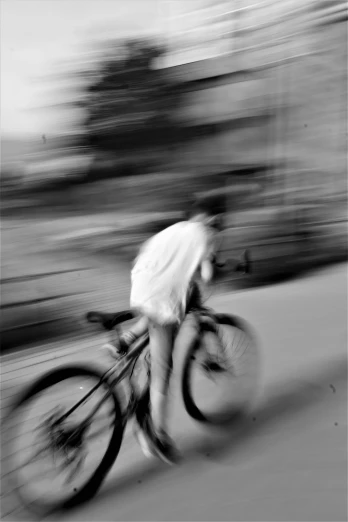 a man riding a bike down a street, inspired by Louis Faurer, blur:-1, monochrome:-2, photographs, abstract photography