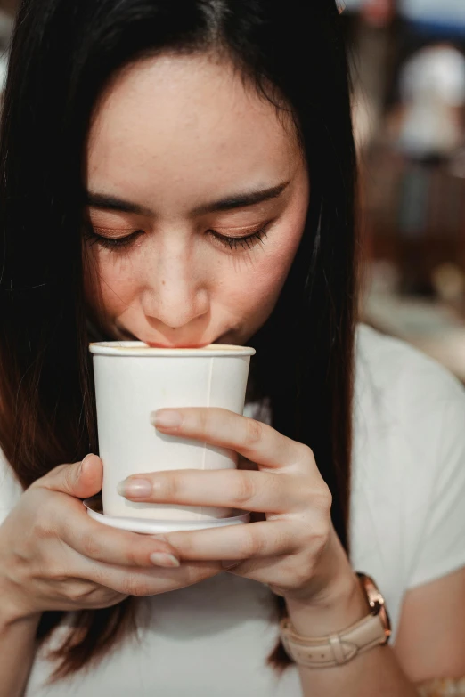 a woman drinking out of a paper cup, trending on pexels, renaissance, smelling good, aussie baristas, girl with dark brown hair, multiple stories