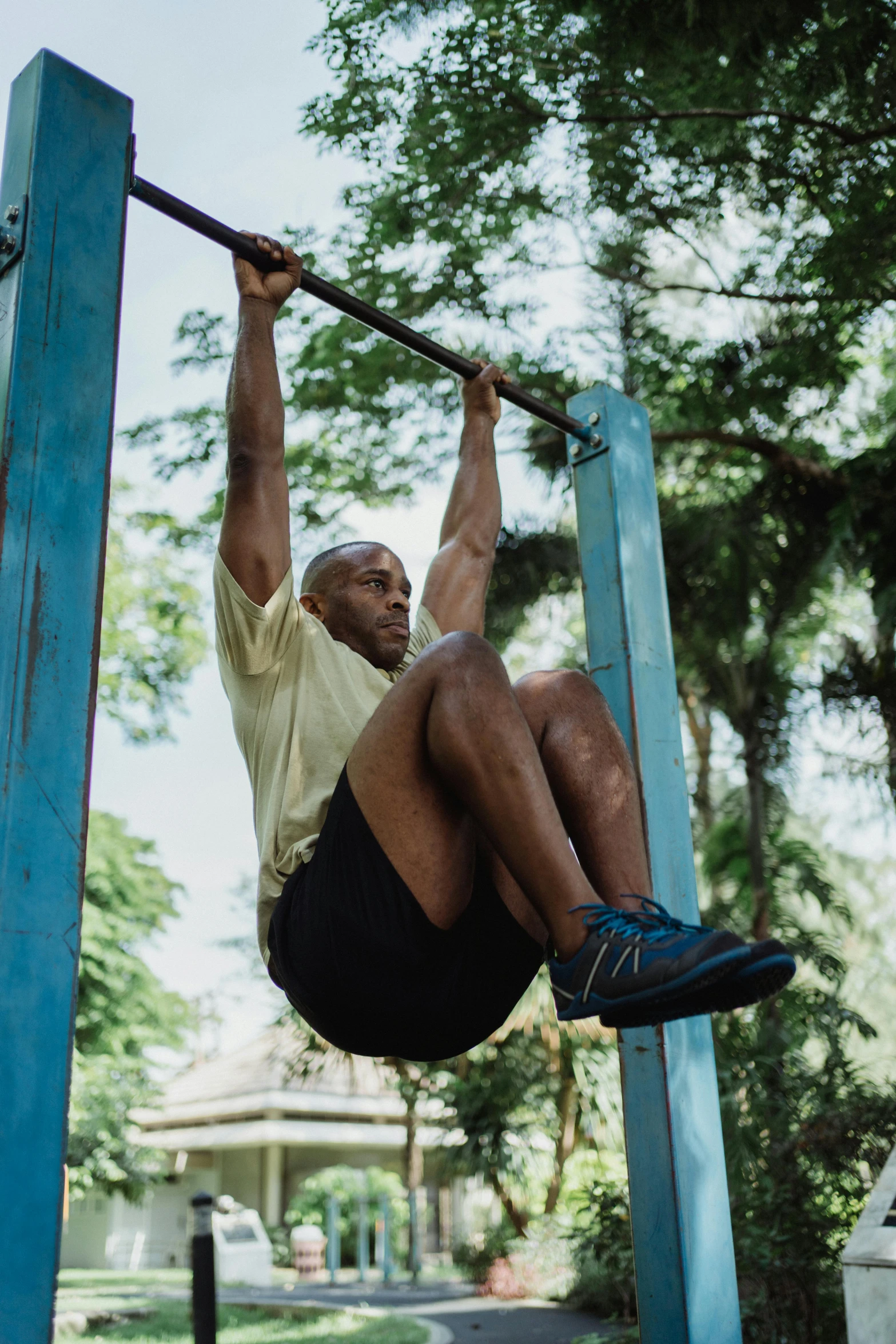 a man on a pull up bar in a park, a portrait, pexels contest winner, jamaican, hanging veins, square, bald man