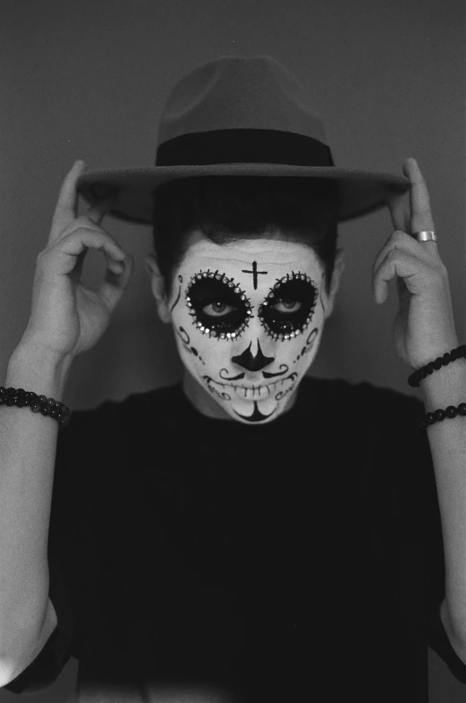 a black and white photo of a man with day of the dead makeup, inspired by Michel De Caso, tumblr, declan mckenna, dark hat, pete davidson, sarah andersen