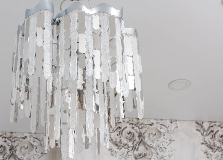 a chandelier hanging from a ceiling in a room, wearing ice crystals, glossy white metal, foil effect, lamp ( ( ( mirror ) ) ) )