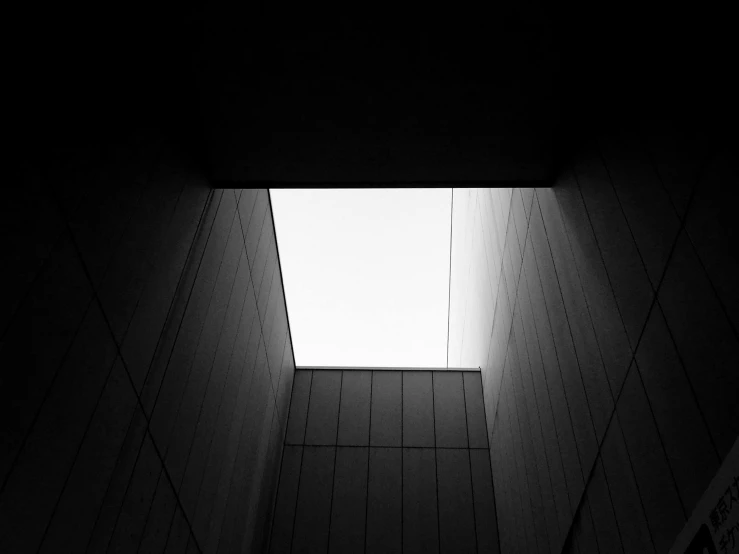 a black and white photo of a skylight in a building, unsplash, minimalism, ffffound, cube portals, mysterious exterior, front lit