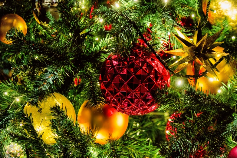 a close up of a christmas tree with ornaments, a photo, by Maksimilijan Vanka, red and yellow light, avatar image, tissue ornament, classical ornament