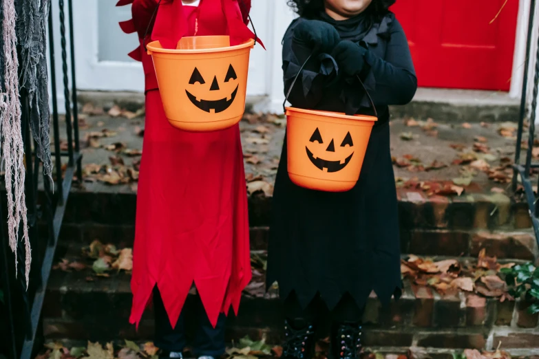 two little girls dressed up in halloween costumes, pexels, antipodeans, dressed in red paper bags, black, pumpkin head, thumbnail