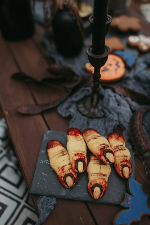 a table that has some food on it, vampire fangs, cookies, detailed close foot shot, exterior shot