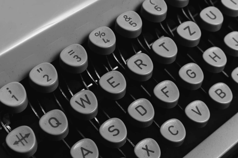 a black and white photo of an old typewriter, unsplash, letterism, grayish, 1970s photo, psion, round format