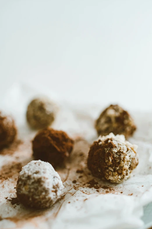 a close up of a plate of food on a table, cannonballs, white with chocolate brown spots, hemp, thumbnail