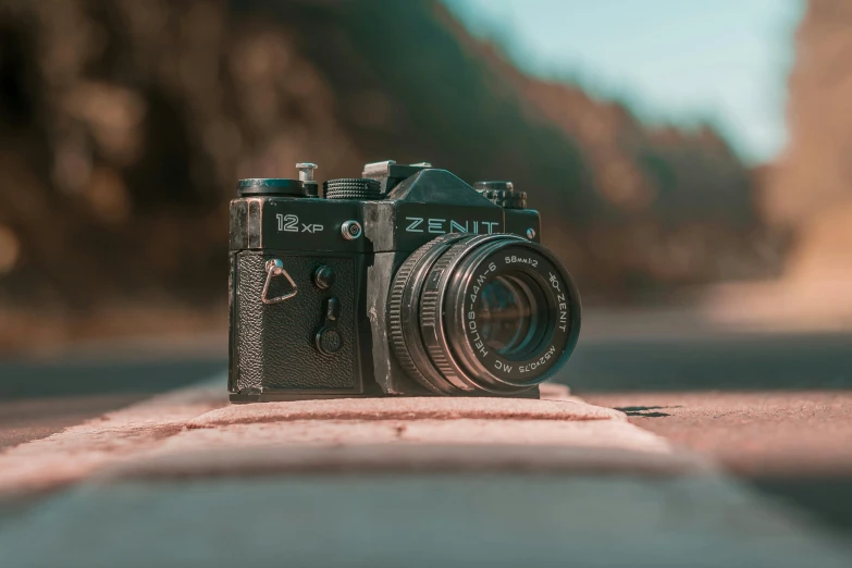 a camera sitting on the side of a road, a picture, by Adam Marczyński, pexels contest winner, photorealism, 8 0 s camera, zenith perspective, medium format, color photograph portrait 4k