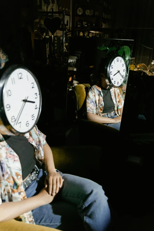 a woman sitting in front of a mirror with a clock on her head, driver, face partially obscured, jon kuo, ralph goings