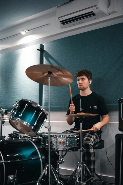 a man playing drums in a recording studio, an album cover, inspired by Seb McKinnon, pexels contest winner, photorealism, looking to his side, charli bowater, lachlan bailey, instagram story