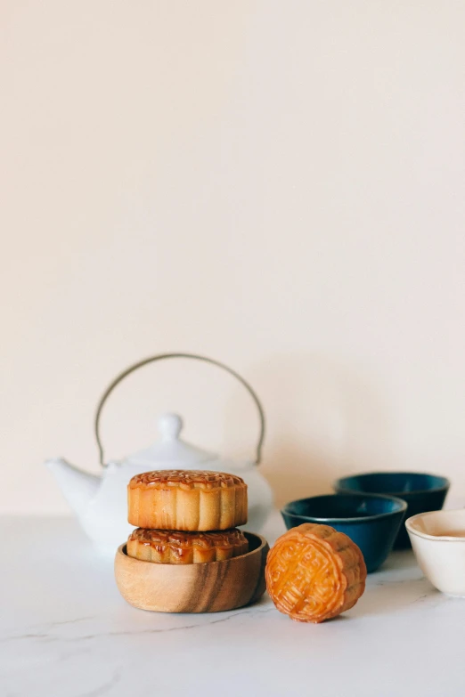 a cup of coffee and some cookies on a table, by Tan Ting-pho, trending on unsplash, cloisonnism, teapots, celebration, crispy buns, soft zen minimalist