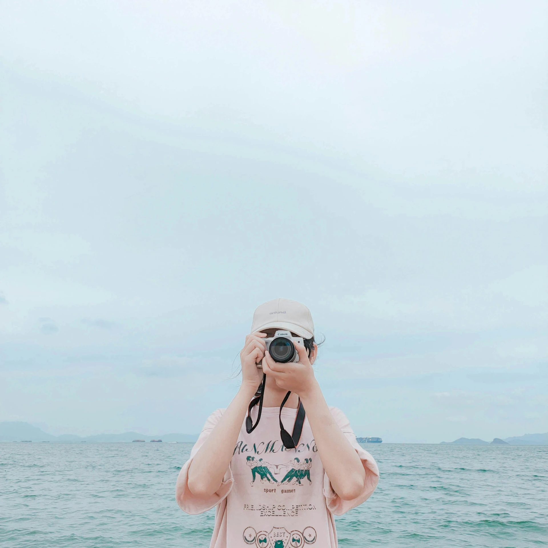 a woman taking a picture of the ocean with a camera, a picture, kawaii aesthetic, pastel clothing, camera face, amy sol in the style of