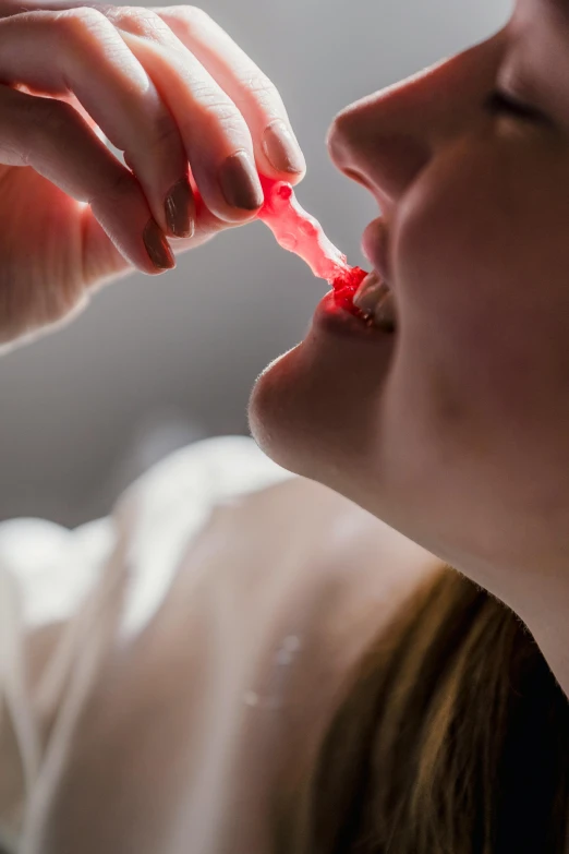 a woman brushing her teeth with a toothbrush, by Adam Marczyński, pexels contest winner, renaissance, made of candy, drinking cough syrup, in ecstasy, medium close up shot