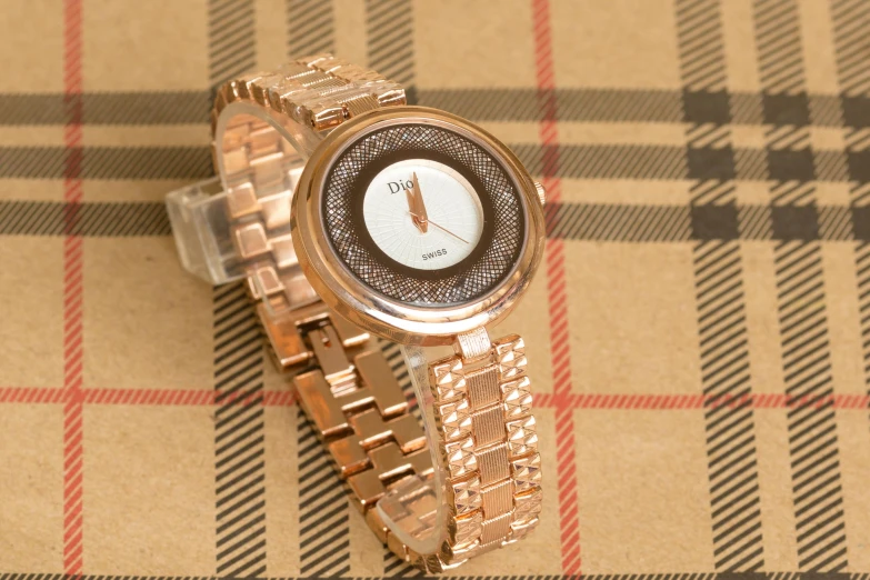 a close up of a watch on a table, glitz pro, rose gold, 555400831, in a medium full shot