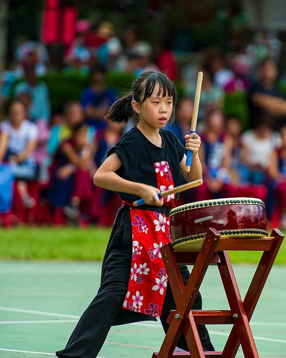 a little girl that is standing in front of a drum, inspired by Miao Fu, pexels contest winner, martial arts tournament, square, touhou, 15081959 21121991 01012000 4k