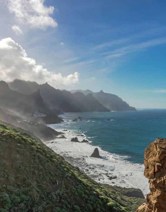 a man standing on top of a cliff next to the ocean, craggy mountains, slide show, olivia de bernardinis, quixel megascans