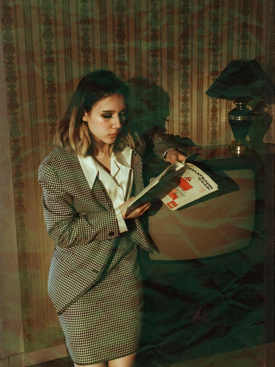 a woman reading a book in a room, an album cover, inspired by Elsa Bleda, magic realism, wearing a worn out suit, ((portrait)), teenager, neotrad