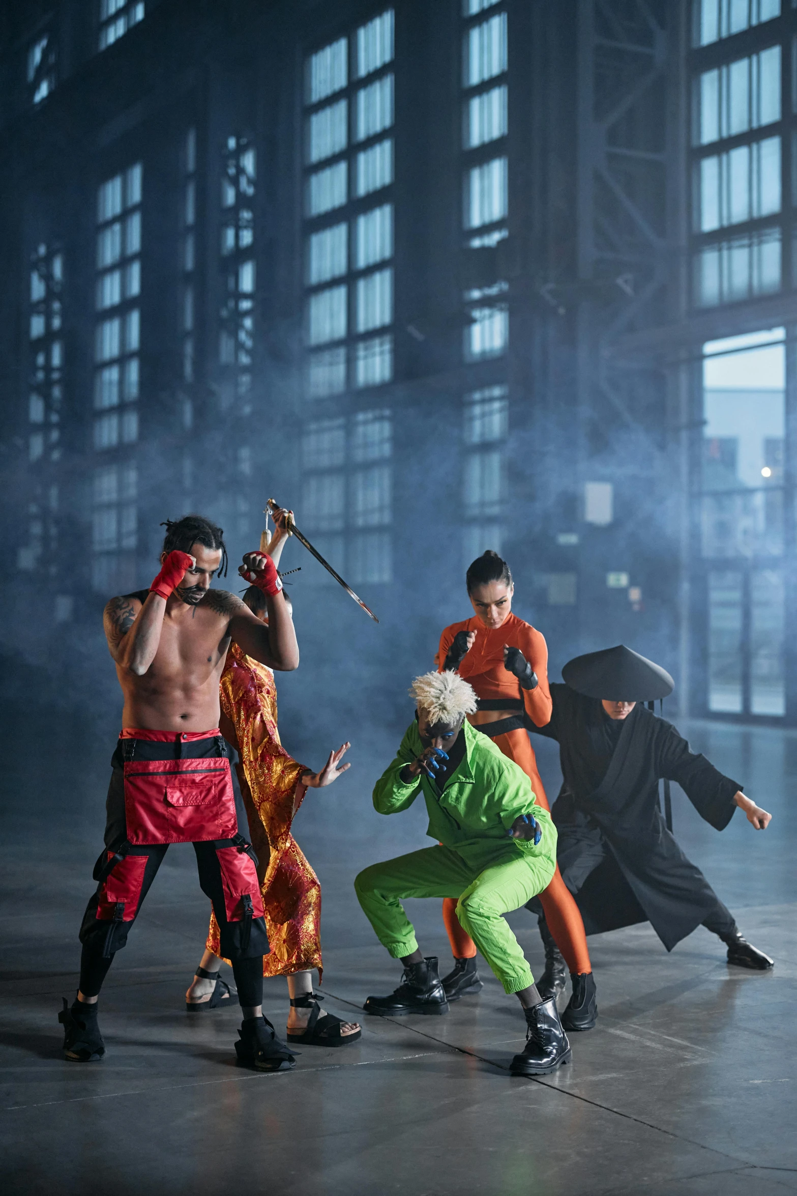 a group of people standing next to each other on a stage, inspired by Kanō Hōgai, conceptual art, ninjas, in a warehouse, photoshoot, in orange clothes) fight