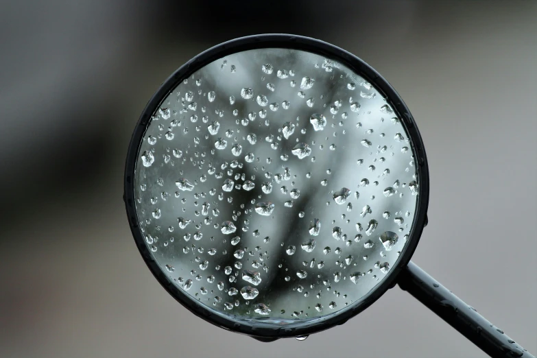 a close up of a rain covered mirror, a microscopic photo, pixabay, magnifying glass, slight overcast weather, round-cropped, grey