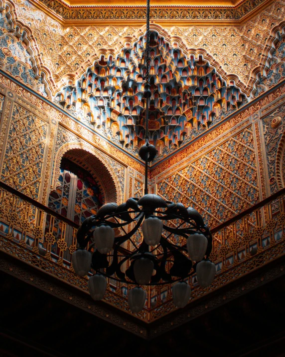 a chandelier hanging from the ceiling of a building, a mosaic, inspired by Luis Paret y Alcazar, unsplash contest winner, arabesque, thumbnail, carved wood, moorish architecture, glossy intricate design